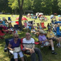 <p>Fans look for shade on the lawn as they enjoy the music at Saturday&#x27;s event.</p>