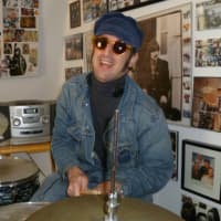 <p>Hastings resident Anthony Ringo-Kulp at his drum kit backed by Beatles memorabilia.</p>