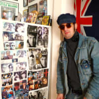 <p>Ringo look-alike Anthony Ringo-Kulp with part of his photo collection.</p>