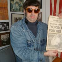 <p>Anthony Ringo-Kulp with a copy of the newspaper detailing John Lennon&#x27;s murder on Dec. 8, 1980.</p>