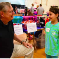 <p>Mayor David Martin talks with a young shopper.</p>