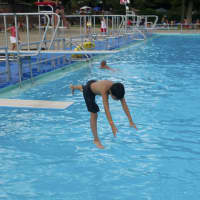 <p>A boy jumps off the diving board at FDR Park&#x27;s pool.</p>