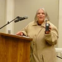 <p>Betty Lovastik of New Canaan holds up the small radio she used during Hurricane Sandy to get information after the power went out. </p>