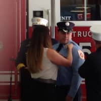 <p>New Wilton Firefighter Eric Tucker receiving his badge.</p>