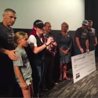 <p>Valerie Jensen, founder of The Prospector Theater, speaks Tuesday as the Yankees contribute $10,000 to the theater, which employs people with disabilities. </p>