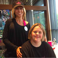 <p>Hope Allison Ciota, sitting, poses with her sister Amy Ciota. Hope, 35, has Down syndrome. Their sister Valerie Jensen founded The Prospector Theater as a place to provide employment for people with disabilities.</p>