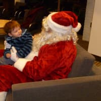 <p>Leo Equale, 23 months, meets with Santa on Friday at the Wilton Holiday Stroll. </p>