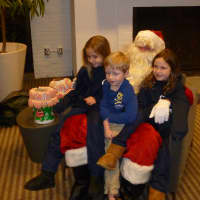 <p>Santa meets with the Ongley siblings. From left, Caitlin, 7, Blake, 4, and Melissa, 6. </p>
