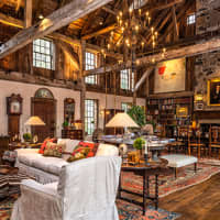 <p>The living room at 50 Zaccheus Mead Lane features soaringly high windows and massive stone fireplaces.</p>