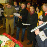 <p>Pound Ridge Community Church Music Director Pete Malinverni, far right, plays the melodica and the leads the crowd in the singing of Christmas carols.</p>
