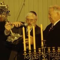 <p>Hecht presents a menorah to Mayor Richard Moccia and the city of Norwalk, which will be on display at City Hall.</p>