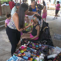 <p>A girl gets her face painted at Family Day.</p>