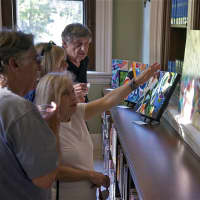 <p>Visitors discuss art at Ridgefield&#x27;s Art Walk.</p>