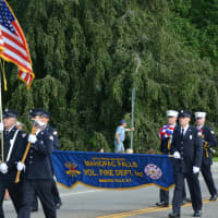<p>Mahopac Falls firefighters march in the Carmel Fire Department&#x27;s 100th anniversary parade.</p>