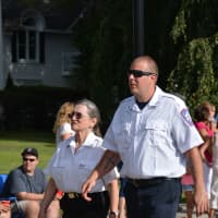 <p>Mount Kisco Volunteer Ambulance Corps members march in the Carmel parade.</p>