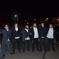 <p>A group of students from Chabad Yeshiva in New Haven, who attending Tuesday night&#x27;s menorah lighting ceremony is Westport, band together to sing a song after the menorah was lit.</p>