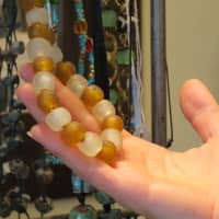 <p>Natalie Kabasakalian shows off jewelry inside The Kindly Fruits, 15 Purchase St., Rye.</p>