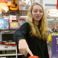 <p>Sarah Hardy, 15, presses the &quot;No&quot; button while at the New Canaan Toy Store. </p>