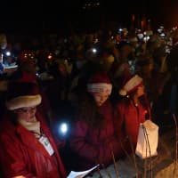 <p>A group of more than 500 people go caroling to 14 homes in Westport&#x27;s Compo Beach area Wednesday to set a new world record.</p>