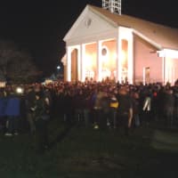 <p>Community members gather for a vigil at St. Rose of Lima Catholic Church in Newtown on Friday evening. </p>