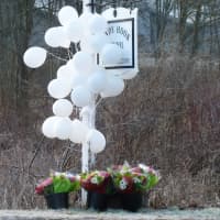 <p>Balloons and flowers surrounded the Sandy Hook School sign in Newtown back in December 2012.</p>