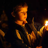 <p>A small boy holds a candle at a vigil on the Village Green in Rye on Sunday night for Friday&#x27;s shooting at Sandy Hook Elementary School in Newtown, Conn.</p>