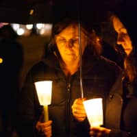 <p>Two women hold candles at a vigil on the Village Green in Rye on Sunday night for Friday&#x27;s shooting at Sandy Hook Elementary School in Newtown, Conn.</p>