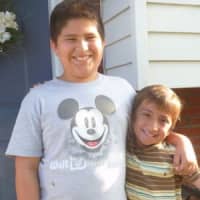 <p>Mateo Din, left, said he might not have escaped an Elmsford home that went ablaze in June if not for the warnings of his younger brother Sebastian, right.</p>