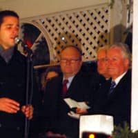 <p>Christian Cardozo of the Bridgeport Theatre Company leads the crowd in a rendition of &quot;Silent Night&quot; at the vigil in Fairfield on Monday.</p>