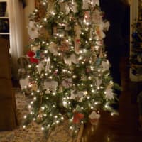<p>Katie Holmstead decorates an angel tree that members of the New Canaan Church of Jesus Christ of Latter-day Saints are making to give to the family of Emilie Parker, one of the Newtown shooting victims. </p>