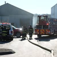 <p>Norwalk firefighters extinguish a dust collector fire Wednesday at D&#x27;Orio Custom Wood Works on Wilson Avenue.</p>