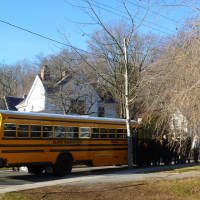 <p>A school bus dropped off a group of Newtown teachers for the service at St. Marys of the Assumption Church Thursday.</p>
