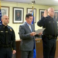<p>Steve Perrotta (left) and Chris Broems (right) take the oath of office as they are sworn in as sergeants with Stamford Police. </p>