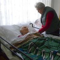 <p>Theresa Travalino, 83, tends to her husband Dean, 95. The family had to struggle in their Edgemont house without power for 11 days following Hurricane Sandy. </p>
