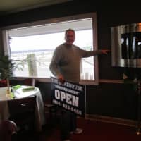 <p>Val Polidoro, co-owner of Ossining&#x27;s The Boathouse Restaurant, points to how high the water rose in the restaurant during Hurricane Sandy. </p>
