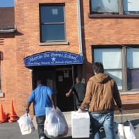 <p>German School students deliver toys and clothes to students at Martin De Porres School in Elmont, N.Y., on the Nassau County border with Queens.</p>