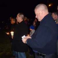 <p>Martin McGannon, right, holds a candle during Thursday night&#x27;s vigil at Jack DeVito Field.</p>