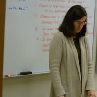<p>New Canaan High School English Teacher Susan Steidl bows her head during Friday&#x27;s moment of silence to remember the victims at Sandy Hook Elementary School in Newtown. </p>