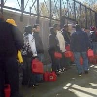 <p>People waited in line for hours to fill their gas cans at gas stations like these in Yonkers.</p>