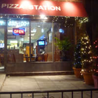 <p>The NY Pizzeria Station has lit-up trees for Christmas.</p>