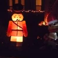 <p>A nutcracker and other inflatable decorations outside a Harrison house.</p>