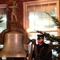 <p>Captain Lawrence Lee of Union Hose Company No. 2 rings the bell in front of Sleepy Hollow Village Hall in honor of the victims of Sandy Hook.</p>