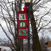 <p>Wilton street lights along River Road are adorned with holiday banners for the season. . </p>