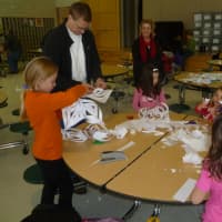 <p>Fairfield families cut snowflakes that will be donated to Sandy Hook School pupils when they start classes at Chalk Hill School in Monroe in January.</p>