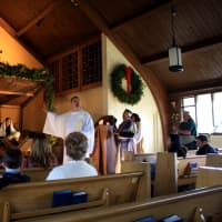 <p>The Rev. Eric Hall. pastor of Eastchester Community Church, addresses his congregation during the live nativity scene Sunday.</p>