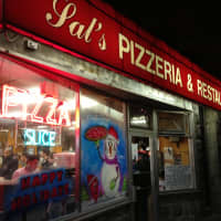 <p>Sal&#x27;s Pizzeria makes their store front festive.</p>