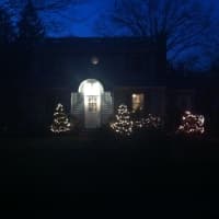 <p>Twinkling Christmas lights shine through the darkness.</p>