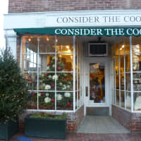 <p>Consider the Cook&#x27;s front window showcases their Christmas tree, which is festively adorned with tinsel and red and white baubles.</p>