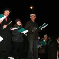 <p>Christmas carolers sing at North Salem&#x27;s Christmas Eve tree-lighting ceremony.</p>