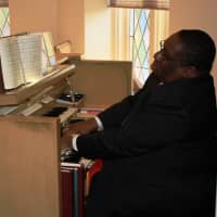 <p>Anthony Newton, organist and choir director for Trinity Lutheran Church, plays during Christmas Mass December 25, 2012.</p>